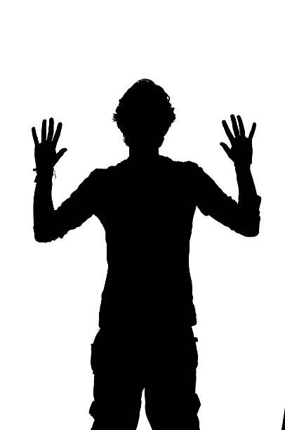 istock silhouette of a man being robbed with hands up 484378537