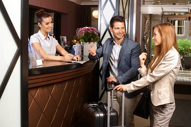 istock Young couple at hotel reception 484378699