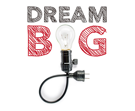 dream big phrase and light bulb, hand writing inspirational positive