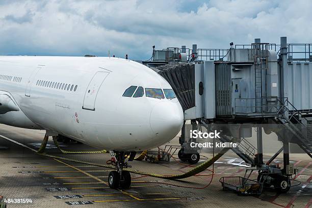 Airplane Near The Terminal In An Airport Stock Photo - Download Image Now - 2015, Air Vehicle, Airplane