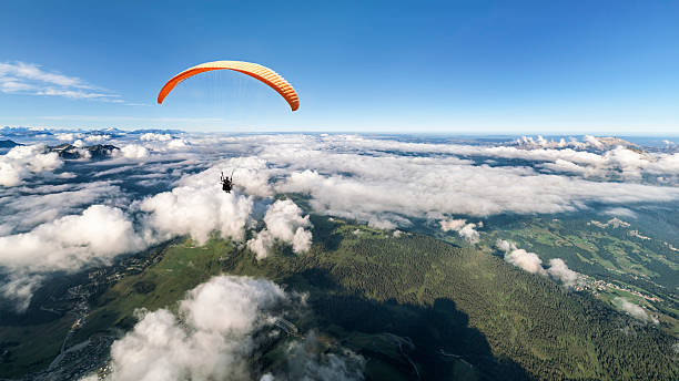 Two-seater paraglider above the clouds stock photo