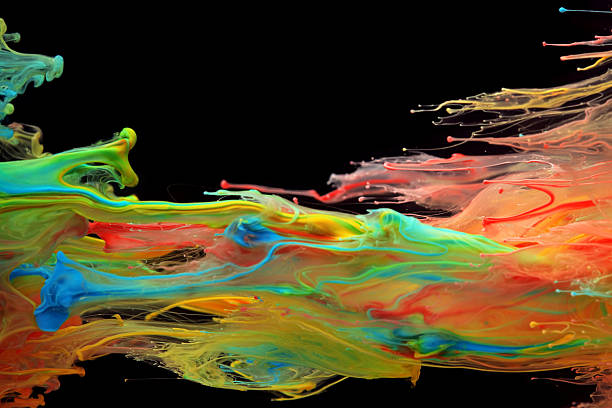 istock Colorful ink swirling through water 484382072