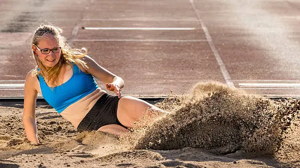 woman in long jump in track and field