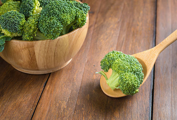 istock Raw broccoli on wooden background 484390288