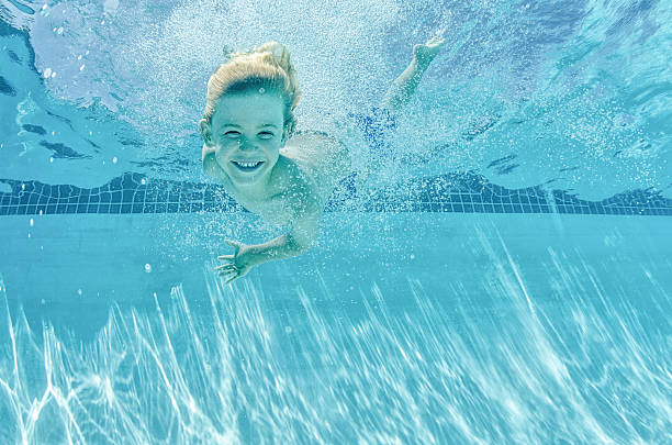 istock Happy swimming boy underwater 484393160