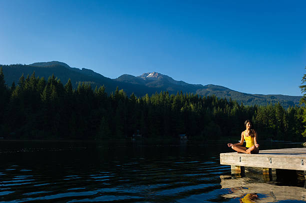 istock Easy Pose Tranquil Lakeside meditation at sunrise 484393304