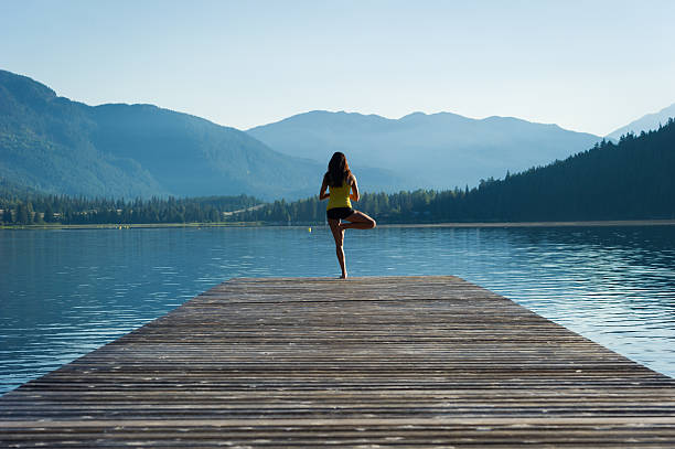 istock Tree Pose Tranquil Lakeside meditation at sunrise 484393318