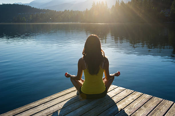 istock Easy Pose Tranquil Lakeside meditation at sunrise 484393328