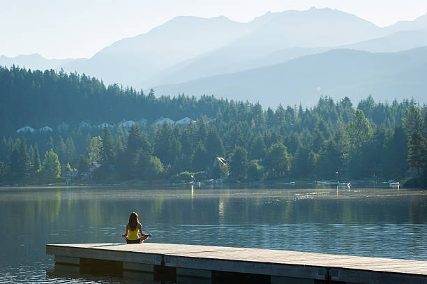 istock Easy Pose Tranquil Lakeside meditation at sunrise 484393332
