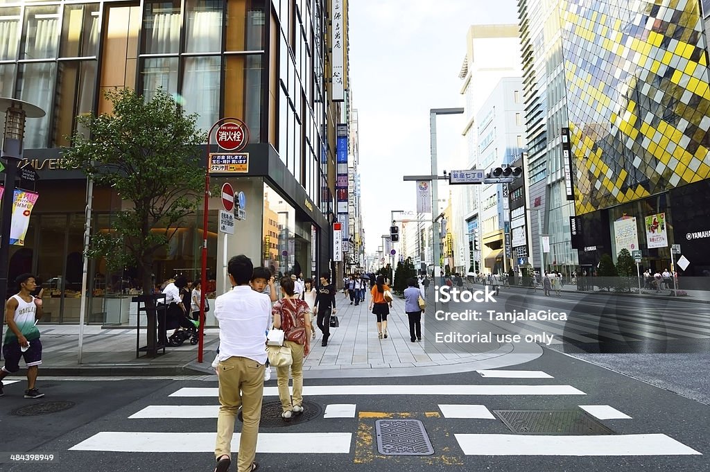 Japanese Crosswalk Tokyo, Japan - August 3, 2013: Pedestrians cross the street at the Shibuya Crossing pedestrian crosswalk the street of Shibuya. The name Shibuya is also used to refer to the central business district of Shibuya Ward, one of Tokyo's busiest railway stations. Shibuya is known as one of the fashion centers of Japan, particularly for young people, and as a major nightlife area. Adult Stock Photo