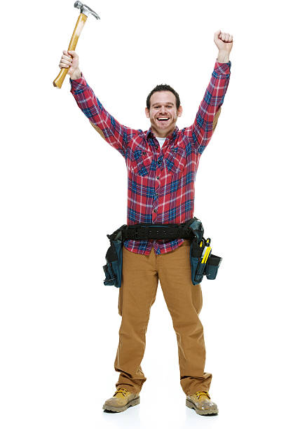 istock Smiling carpenter holding hammer with hand raised 484400005