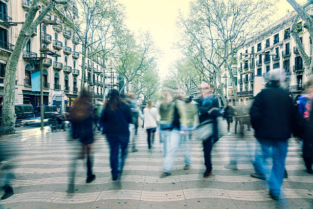 Motion blurred commuters on street stock photo
