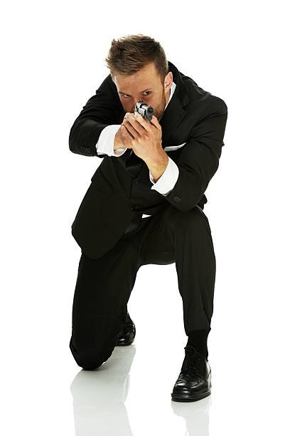 istock Businessman in action with gun 484400515