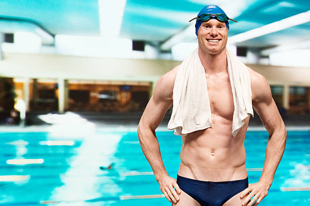 istock Happy swimmer standing in front of swimming pool 484400689