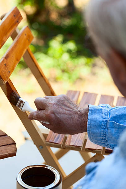 istock Old man painting chair 484400711