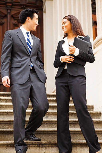 istock Legal or Business Professionals Walking Down Staircase 484400833