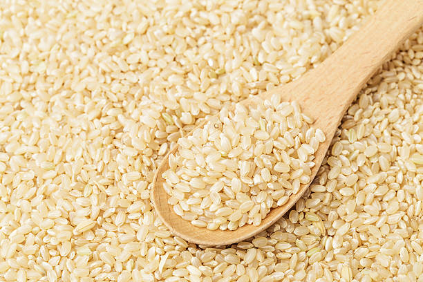 istock Brown rice on wooden teaspoon 484405211