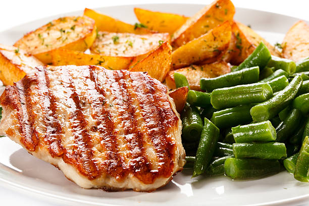 istock Grilled steak, baked potatoes and vegetables on white background 484406199