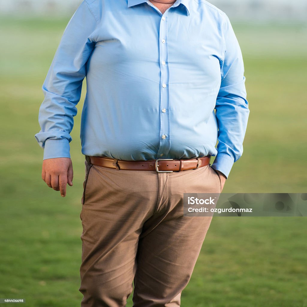 Mid section of an overweight mature man Mid section of an overweight mature man, close-up. Square composition. Image taken with Nikon D800 and developed from Raw format 2015 Stock Photo