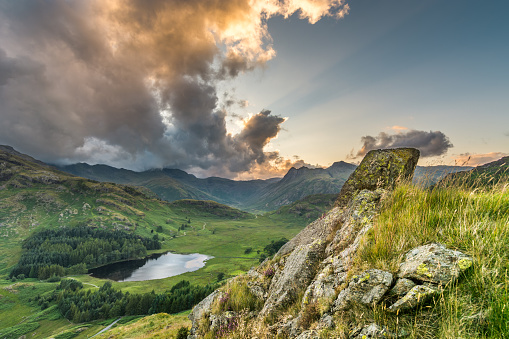 A photograph of Blea Tarn and the surrounding fells in the English Lake District. I climbed up Birk Knott, a small fell, five minutes away from the National Trust car park and was given this stunning view. To the right of the image, the sky was clear. To the left, there was some clouds coming over the mountains creating a dramatic atmosphere. I took 3 single exposures at 2 stops apart and then merged them together in the HDR software in Lightroom CC. The orange colour in the sky was then brought out by adjusting the saturation and luminance.