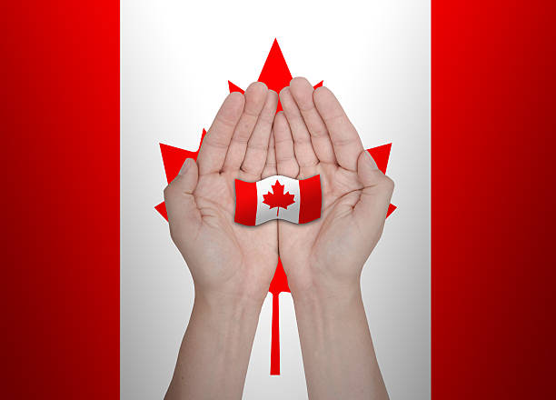 istock Hands protecting the national flag of Canada 484407710