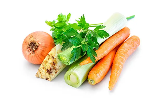 Mirepoix. Ingredients for vegetable broth, carrots, onion, leeks, celery, parsley on white background
