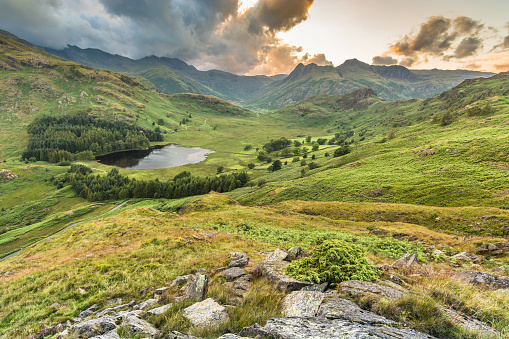 A panoramic view of Blea Tarn and the surrounding fells in the English Lake District. The photograph was taken from Birk Knott, a small climb five minutes away from the National Trust car park. Kirk Knott offers a stunning view of Blea Tarn and in the summer months, beautiful sunsets occur. Taken with a Nikon Nikkor 12-24mm wide angle lens.