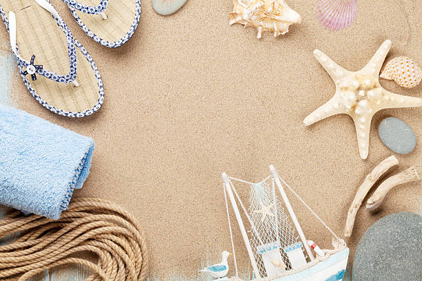 istock Travel and vacation items on sea sand 484411584