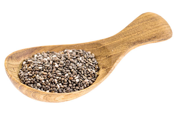 чиа семян на деревянный стол. ложки - tablespoon chia healthy eating seed стоковые фото и изображения
