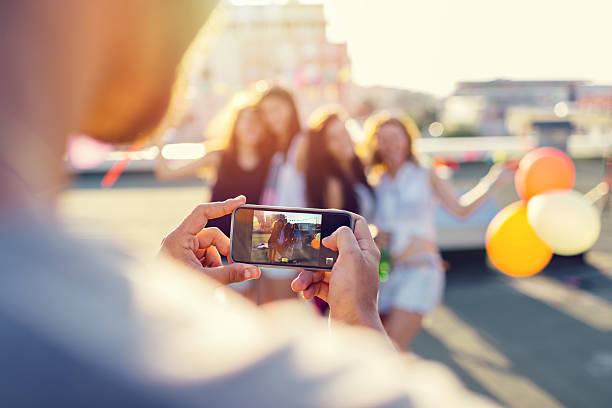 istock Friends photographing on the rooftop 484414924