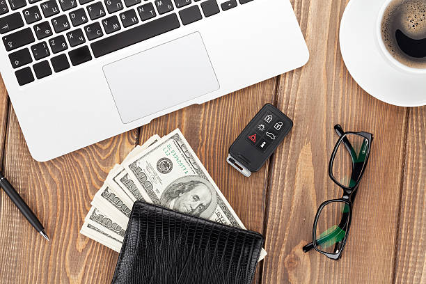 istock Office table with pc, coffee cup, glasses and money cash 484416648