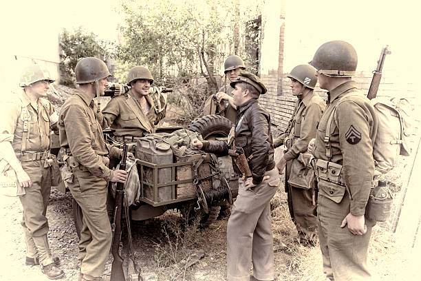 WWII Soldiers Get Ready to Go Out on Patrol World War II Soldier get ready to go out on patrol for the enemy. (vignette) world war ii photos stock pictures, royalty-free photos & images