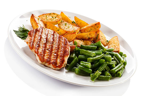 istock Grilled steak, baked potatoes and vegetables on white background 484426643