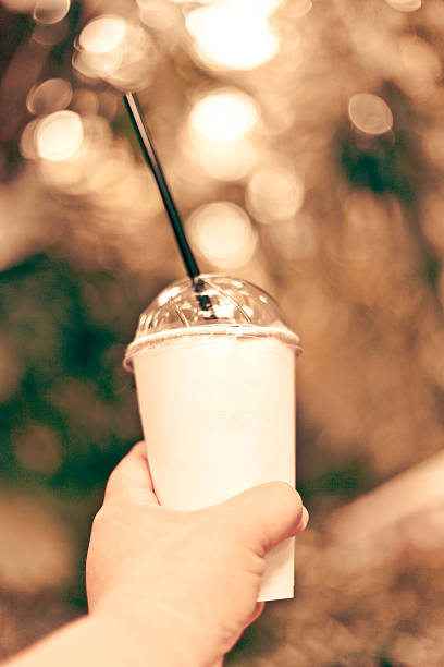 istock man is holding a brown paper cup 484427000