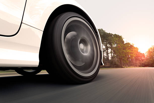 istock White Car Driving into the Sunset 484427189