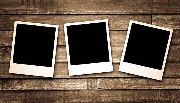 istock Blank photo frames on wood background 484427946