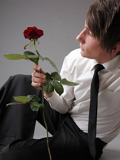 istock Portrait young man and rose enamoured love 484428426
