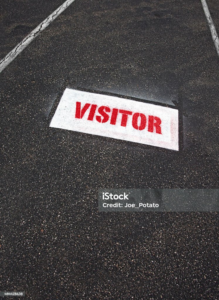 Visitor Parking Stencil on Asphalt Red and white Visitor parking  sign stenciled on asphalt parking space. Vertical. 2015 Stock Photo