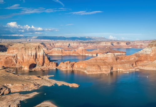 Lake Powell. USA. Grandiose huge lake of artificial origin among the picturesque red sandstone cliffs. The coast is cut by narrow canyons.