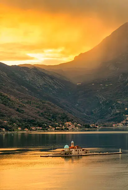 Colorful sunset at the Our Lady of the Rock at Perast, Montenegro.