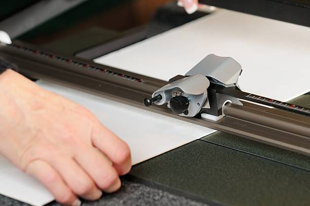 istock Close up of woman using mat cutting machine 484432296