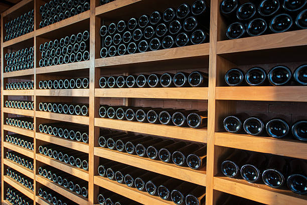 istock Wine bottles on wooden shelves 484432696