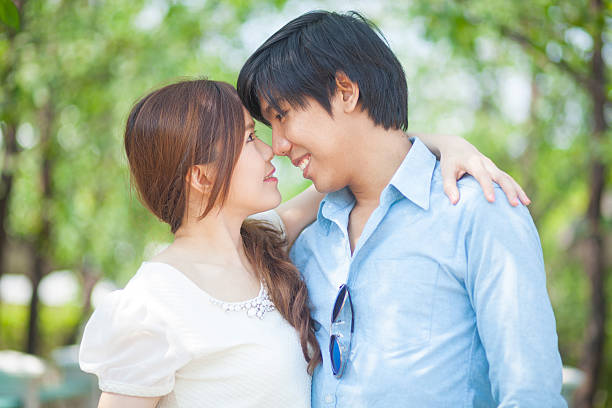 istock Loving asian couple under tree in the park 484441438