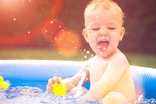 istock Baby splashing water in the small pool 484445168