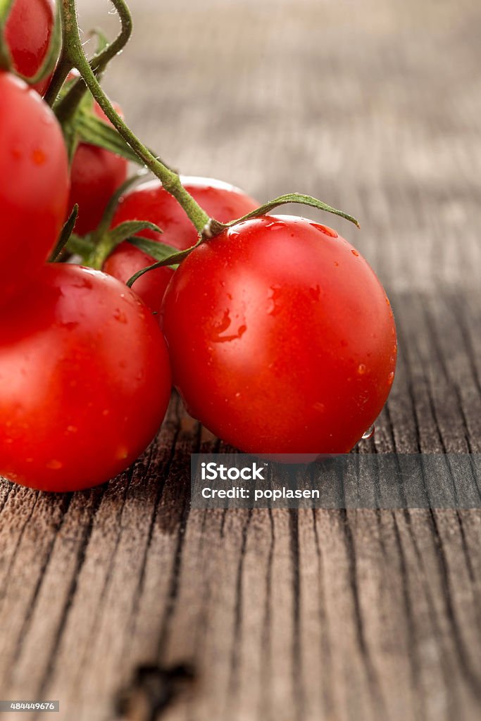 Cherry tomatoes Fresh cherry tomatoes on a wooden table 2015 Stock Photo