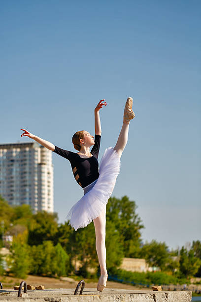 istock Ballerina in tutu dancing on the waterfront. 484452834