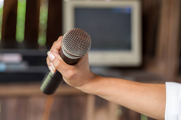 istock Old black microphone in hand, depth of field 484456336
