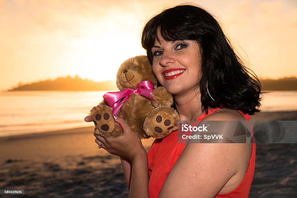 Outdoor shot of young pregnant woman in red dress Pregnant Stock Photo