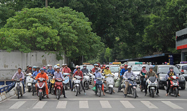 people on crossroad are waiting the green signal of traffic Hanoi, Vietnam - June 2, 2015: people on crossroad are waiting the green signal of traffic light asian women in stockings stock pictures, royalty-free photos & images