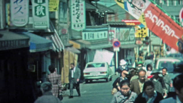 1972: People shopping at outdoor Japanese marketplaces and city streets.